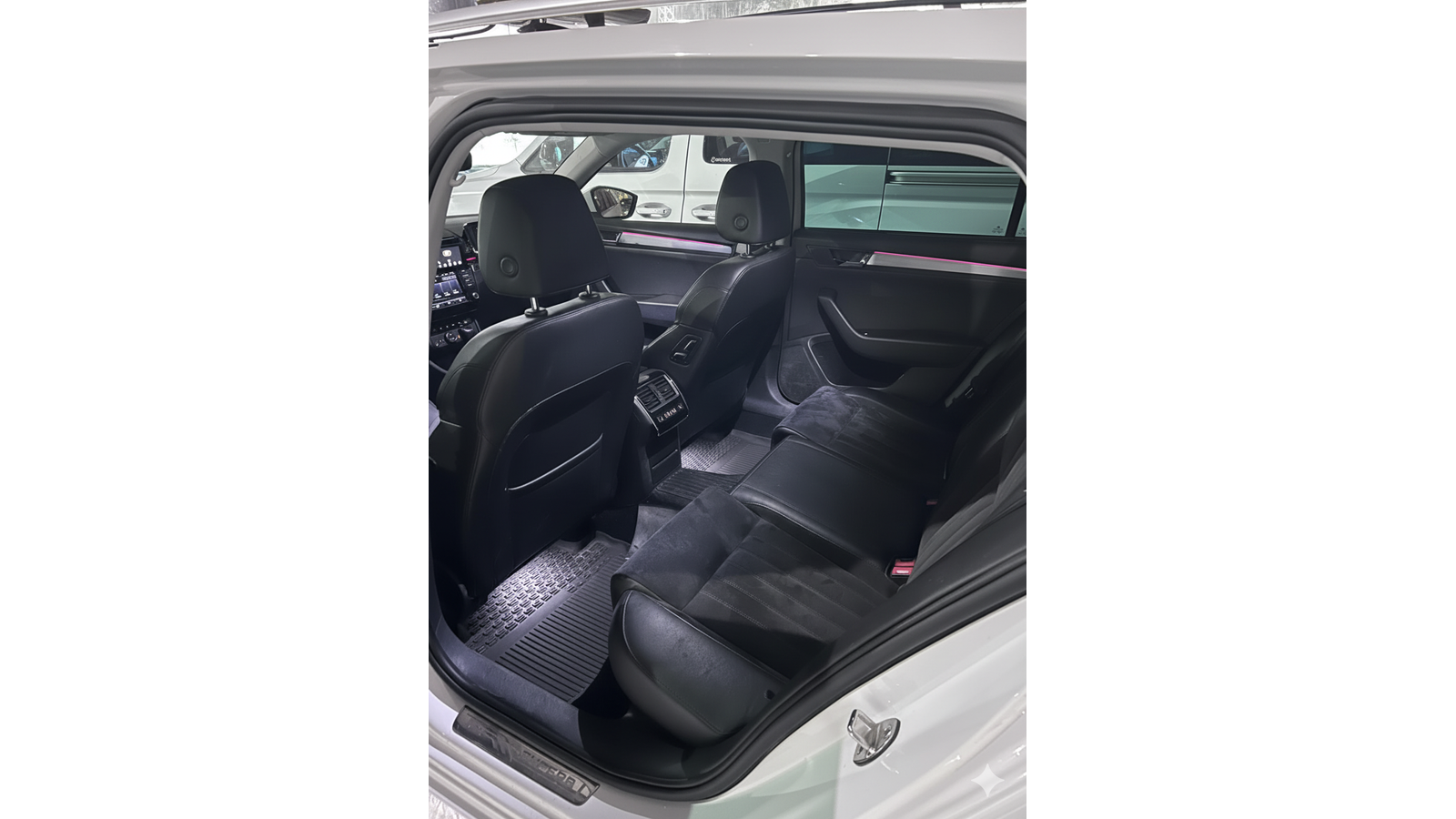 Taksi Wallin Oy:n henkil&ouml;autotaksin siisti ja tyylik&auml;s matkustamo. Kuvassa n&auml;kyv&auml;t mustat istuimet, tunnelmavalaistus ja valaistut jalkatilat.